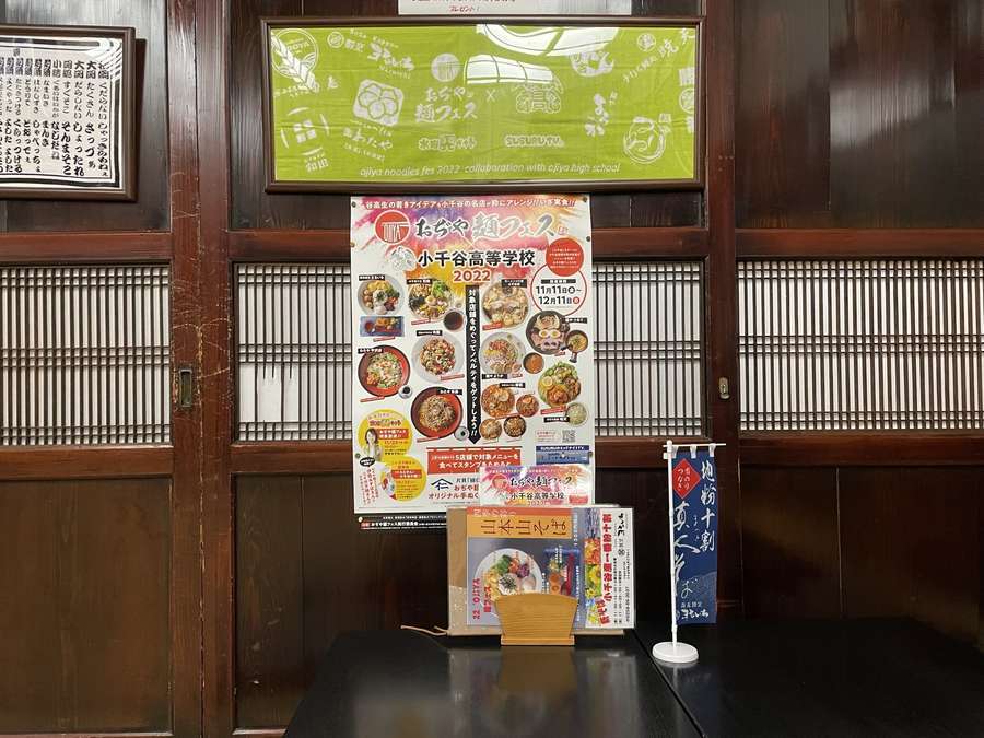 まるいち店内に貼られたおぢや麺フェス関連のポスターやノベルティ