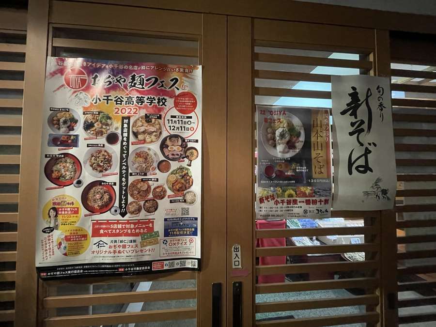 まるいち店舗入り口に貼られた麺フェスのポスターと参加メニューの案内